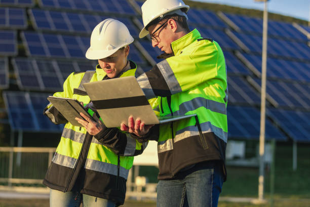 istock Two engineers discussing operation of solar power station 1501658051