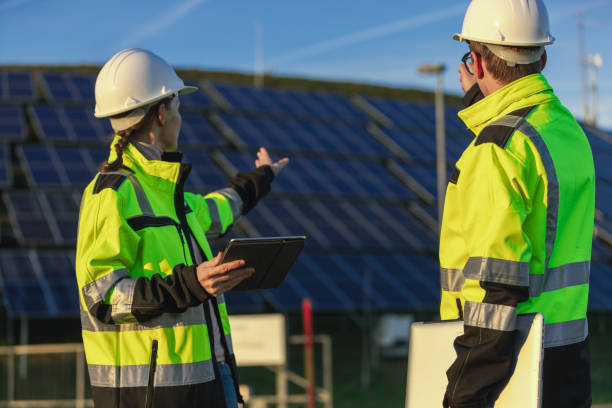 istock Two engineers discussing operation of solar power station 1501658095