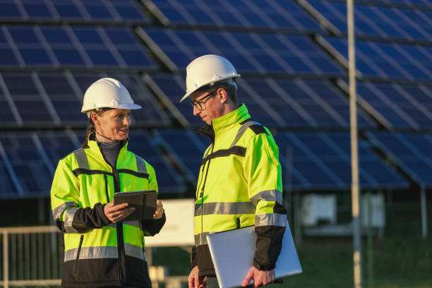 istock Two engineers discussing operation of solar power station 1501659141