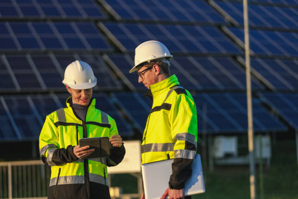 istock Two engineers discussing operation of solar power station 1501660829