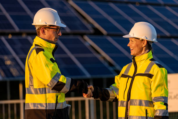 istock Two engineers in reflective clothing shaking hands at solar power station 1501662203