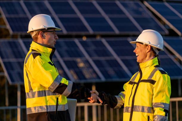 istock Two engineers in reflective clothing shaking hands at solar power station 1501664515