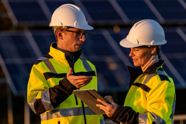 istock Two engineers discussing operation of solar power station 1501666294