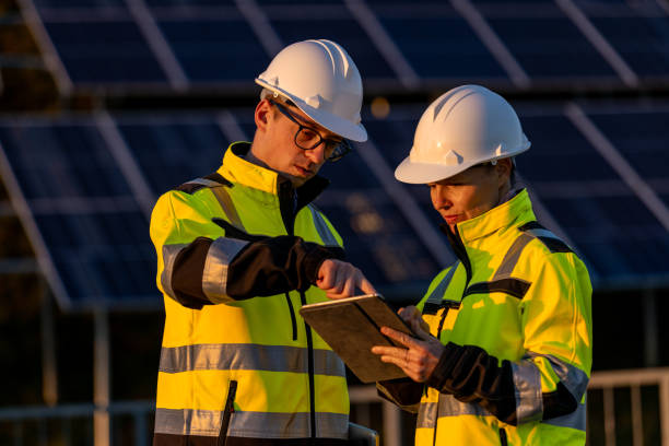 istock Two engineers discussing operation of solar power station 1501668522