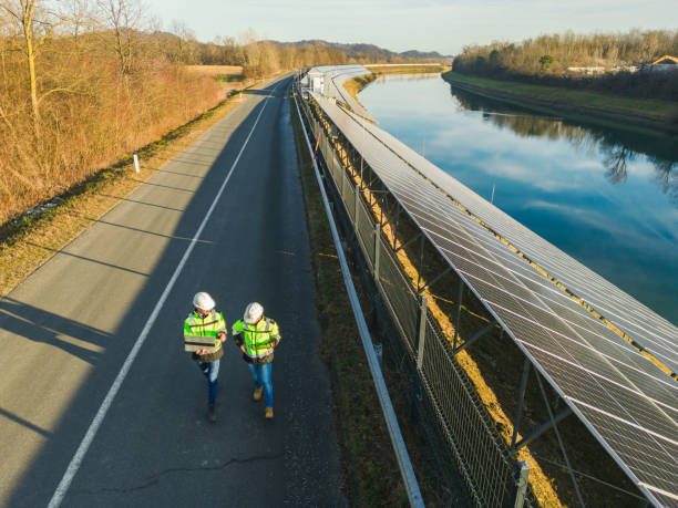 istock AERIAL VIEW  Two engineers using laptop next to solar power plant by river 1501674115