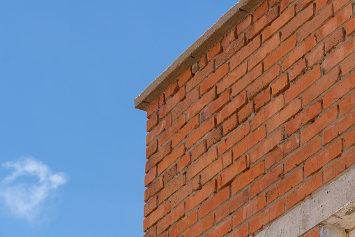 Red brick stone building on blue sky
