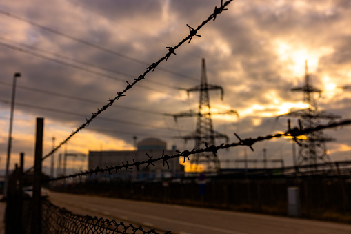 High voltage power lines against the sky. Electricity pylon and electric power transmission lines during sunset