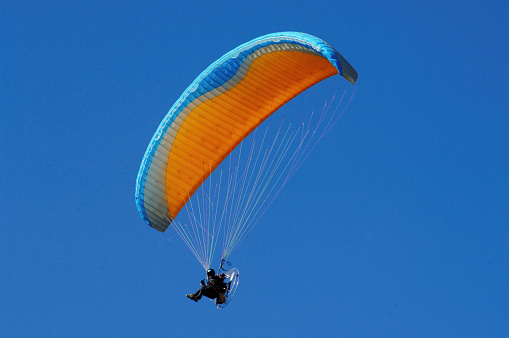 Paragliders are practicing flying in the blue sky, An Giang province, Mekong Delta