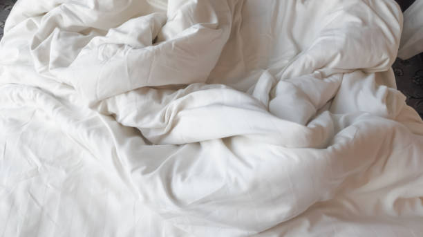 istock Selective focus of disheveled and wrinkled white soft linen blanket 1501686107