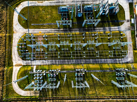 Aerial view of electrical power substation on green rural field