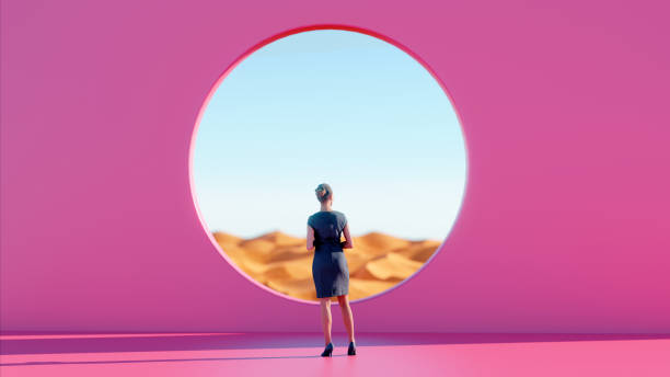 Woman Finds Peace Standing Before Pink Wall while Gazing into Desert stock photo
