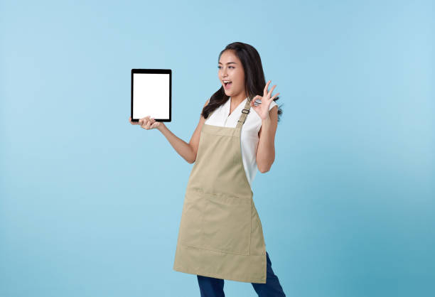 istock Entrepreneur asian woman showing tablet with blank screen isolated on blue studio background. presenting advertising application 1501692368
