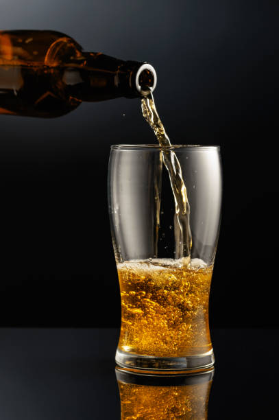 istock Pouring beer from a bottle into a glass. 1501720586