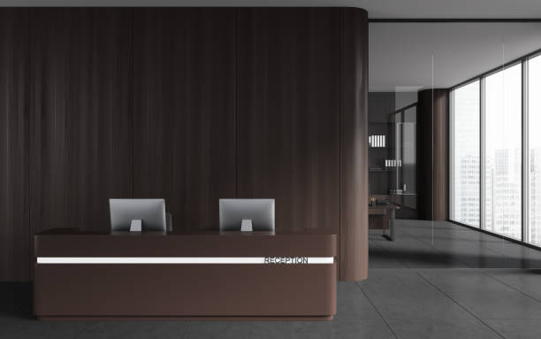 istock Dark reception interior desk with computers and business room. Empty wall 1501721118