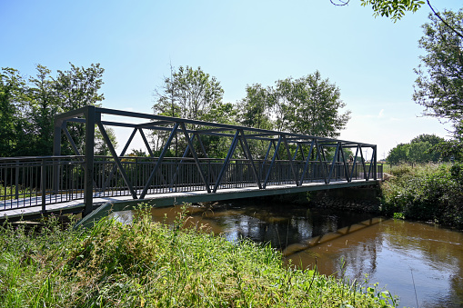 Neuss, June 24, 2023 - Erft bridge near Minkel for pedestrians and cyclists in the district of Neuss.
