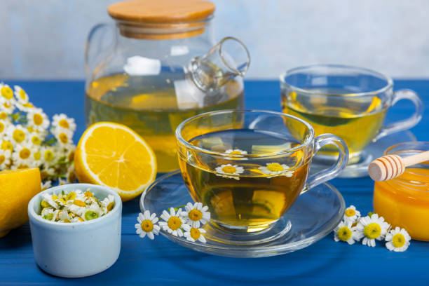 istock Chamomile tea in a  cup on a blue textured background. Natural hour with chamomile flowers. Herbal tea. Immunity tea.Natural healer concept. Healthy detox drink.Close up. Place for text. 1501738361