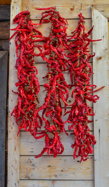 istock Hanging red chilli on wooden wall 1501738396