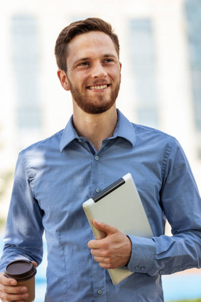 istock Businessman with a tablet and coffee working outdoors 1501742495