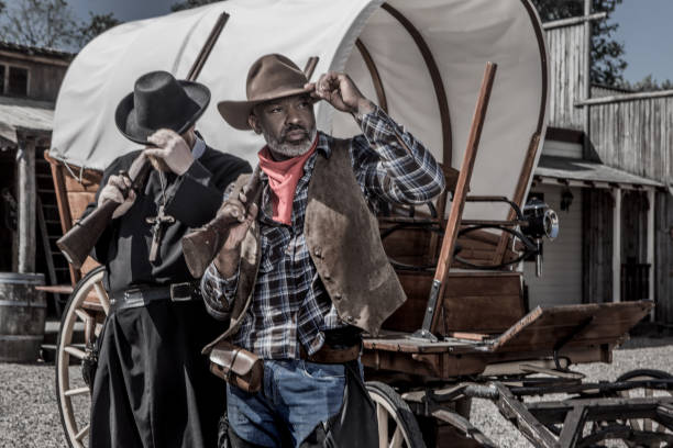 istock Handsome Black Cowboy with a priest in an authentic wild west setting 1501747858