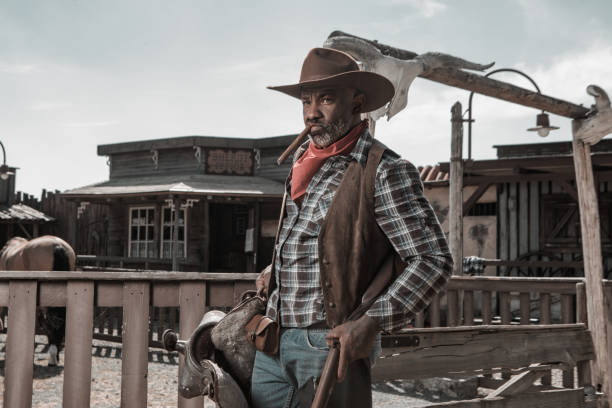istock Handsome Black Cowboy in an authentic wild west setting 1501747914