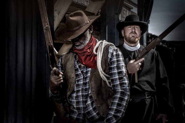 istock Handsome Black Cowboy with a priest in an authentic wild west setting 1501747933