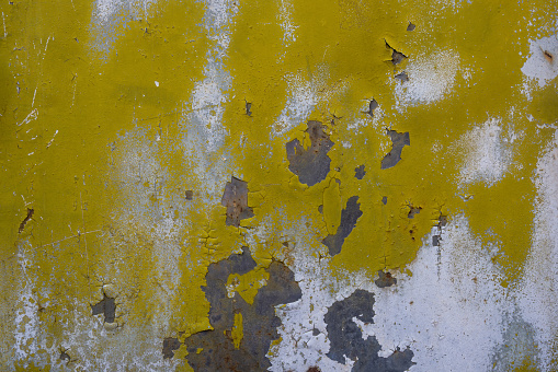 Texture of rusty iron stained in yellow and white