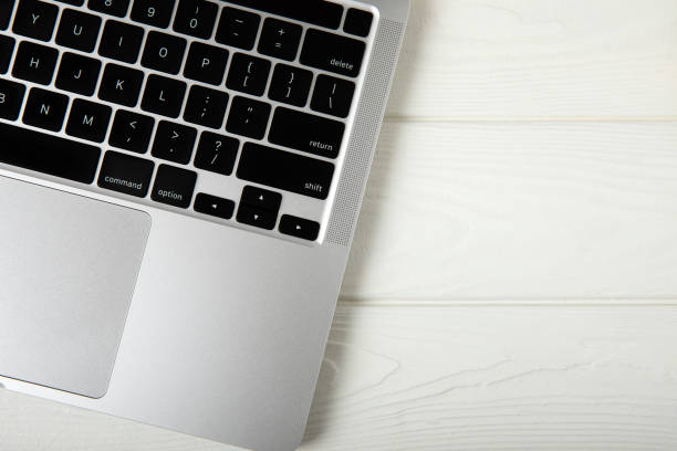 istock Home office still life. Laptop mockup, computer blank screen. Mite on a wooden table. Brown wall background. Scandinavian interior. 1501752777