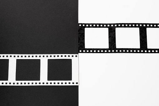 White and black photography or film negative frame isolated on black and white background in horizontal position. With copy space.