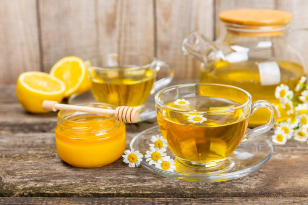 istock Chamomile tea in a  cup on a brown textured background. Natural hour with chamomile flowers. Herbal tea. Natural healer concept. Healthy detox drink.Close up. Place for text. Copy space. 1501755300