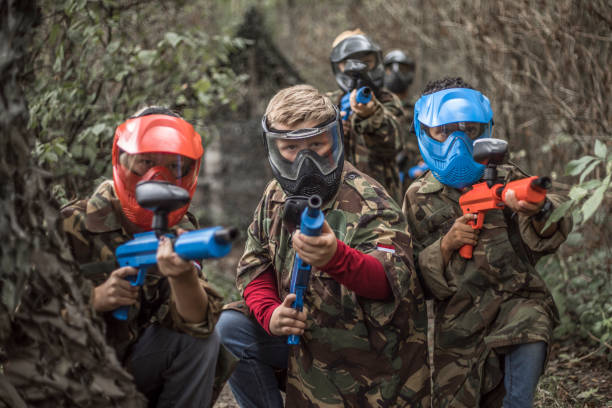 istock Young children playing paintball together during a skirmish 1501759082