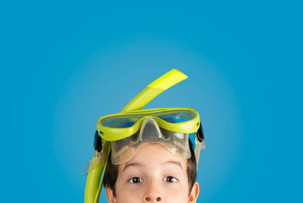 istock boy with mask scuba over blue background 1501759536