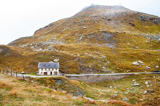 Mountain landscape with old house on the top of the mountain.