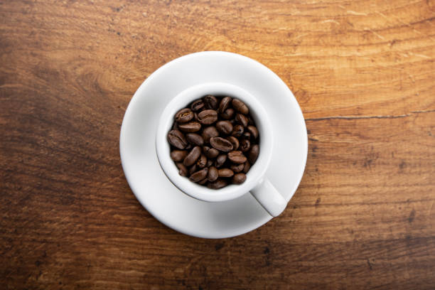 Roasted coffee beans in a cup stock photo