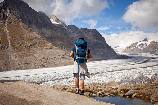 Hike with a backpack to the Aletsch Glacier in Swiss Alps