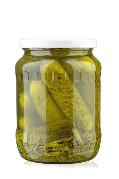istock Canned cucumbers in a jar. Isolated on white background. 1501769197