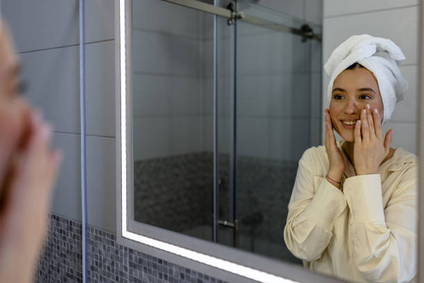 istock A young woman in a bathrobe is doing make-up inside the house. 1501773694