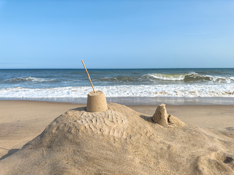 Close-up of sandcastle built on seaside by boy on summer island vacations