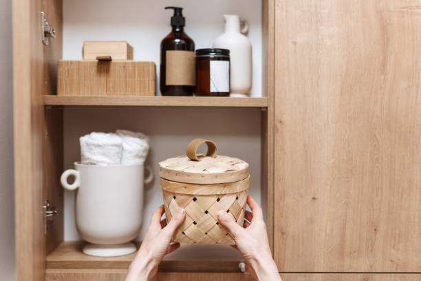 istock woman take storage box with hygiene products from cupboard 1501778403