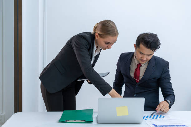 istock two people working together in the office 1501781473