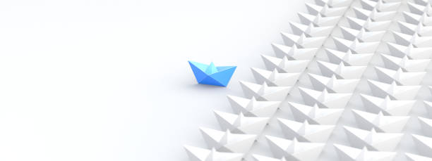 Leadership concept, blue leader boat, standing out from the crowd of white boats stock photo