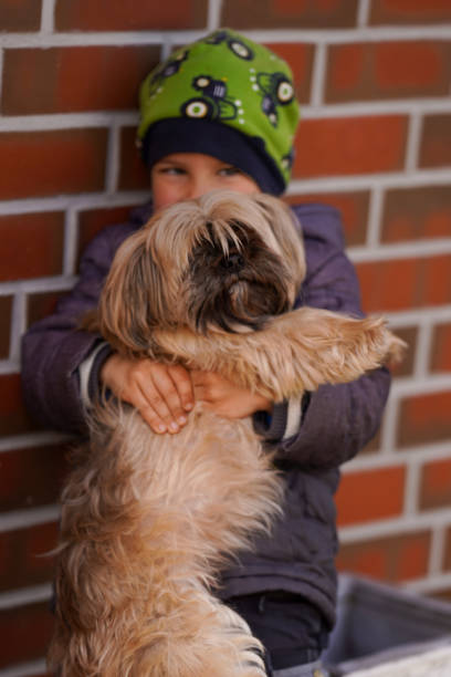 istock Little boy lovingly hugging his dog. Focus on the dog. 1501785204
