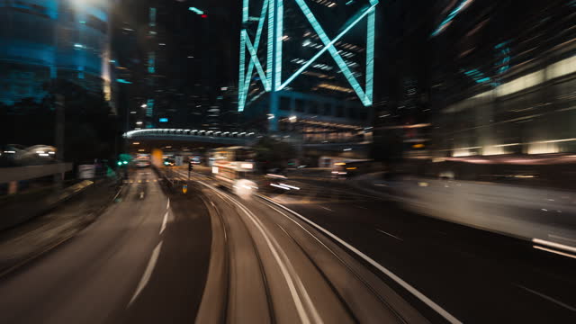 Point of view hyperlapse time lapse of tram train traveling in Hong Kong city downtown at night. Public transport, Car traffic transportation, Asia travel, commuter lifestyle concept