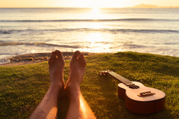 istock Woman relaxing by the beach with ukulele. 1501785400