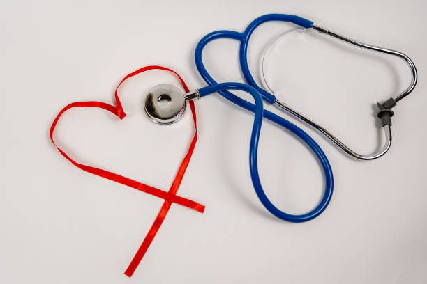istock a phonendoscope rests inside a red ribbon shaped in the shape of a heart 1501785678