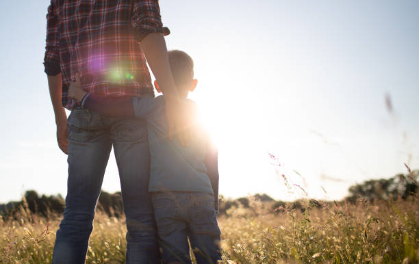 Young father and son spending time together bonding in nature.