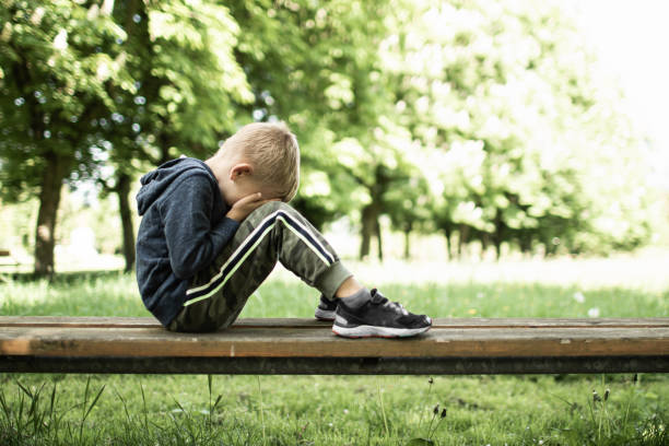 istock Sad little boy in the park 1501785930