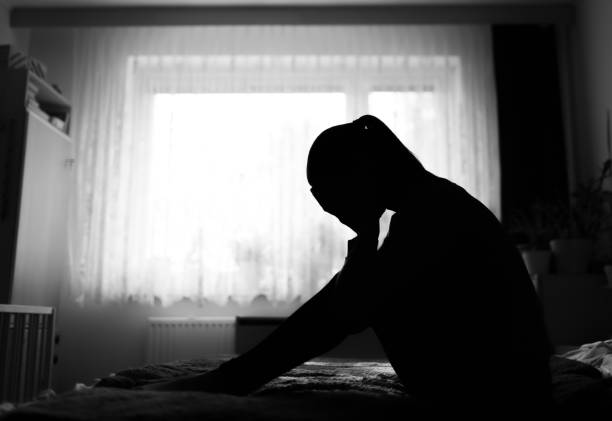 istock Sad distraught woman in her room at home. 1501786039
