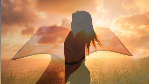 istock Young woman praying. Hand holding Bible. 1501786925