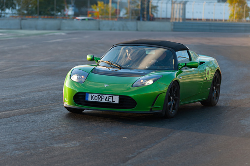 Gothenburg, Sweden - september 28 2012: Green electric Tesla roadster driving hard at a race course.