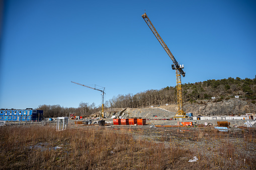 Gothenburg, Sweden - April 02 2023: Two construction cranes at a construction site.